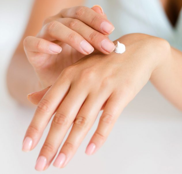 Close up of woman applying moisturiser to her hands in self care, showing you how to feel more confident about your body